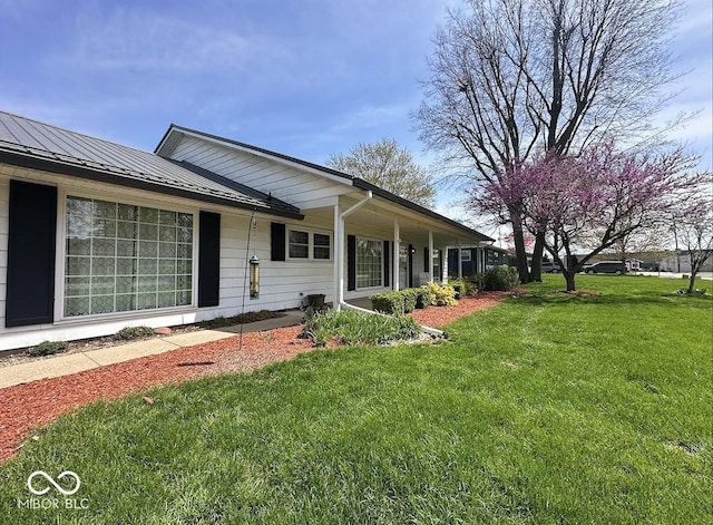 1406 Durham Dr, Crawfordsville, IN 47933 - exterior space featuring a lawn, a standing seam roof, and metal roof