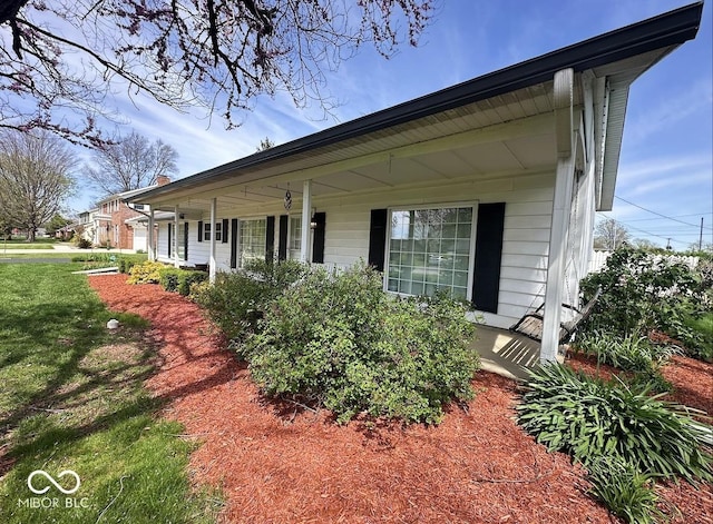 1406 Durham Dr, Crawfordsville, IN 47933 - view of property exterior featuring a porch and a yard