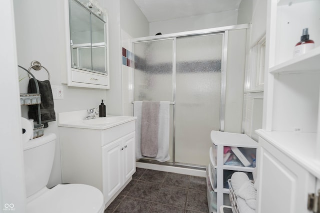 full bath with a stall shower, tile patterned flooring, vanity, and toilet