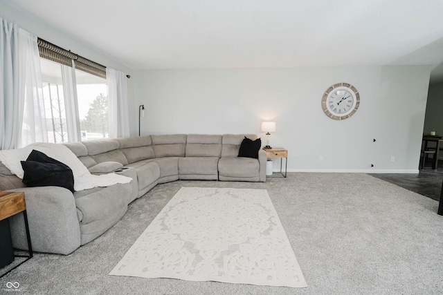 living room featuring carpet and baseboards