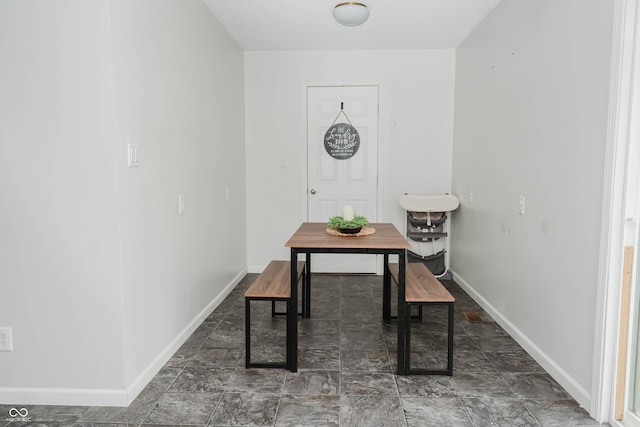 dining area featuring baseboards