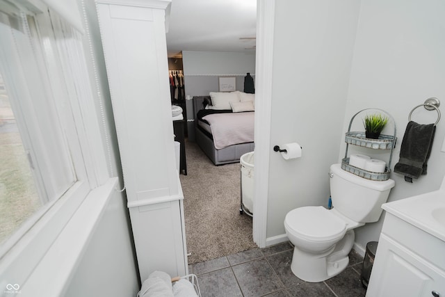 bathroom with vanity, toilet, and baseboards