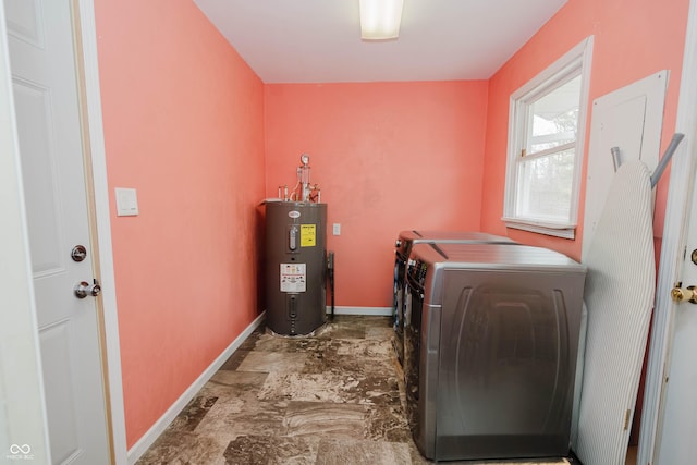 laundry area with laundry area, water heater, baseboards, and separate washer and dryer