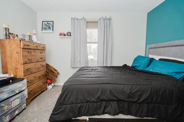 carpeted bedroom with baseboards