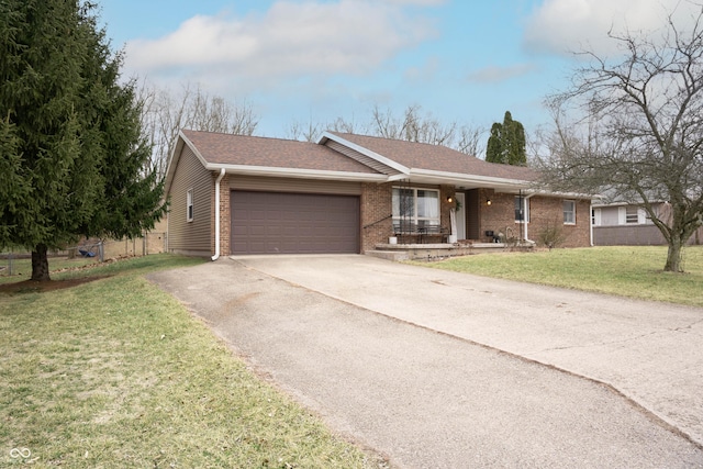 ranch-style home featuring driveway, a chimney, an attached garage, a front lawn, and brick siding