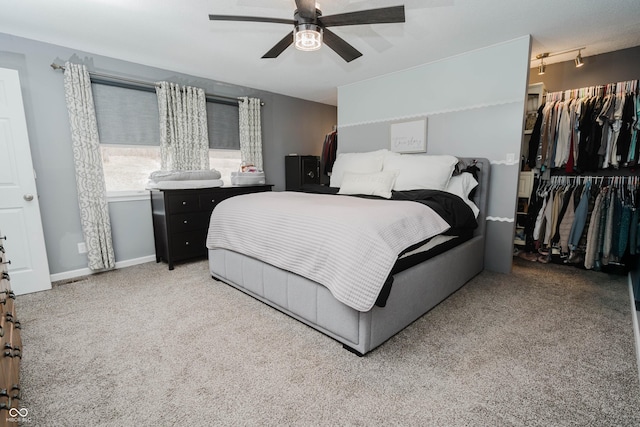 bedroom with ceiling fan, a closet, carpet flooring, and baseboards