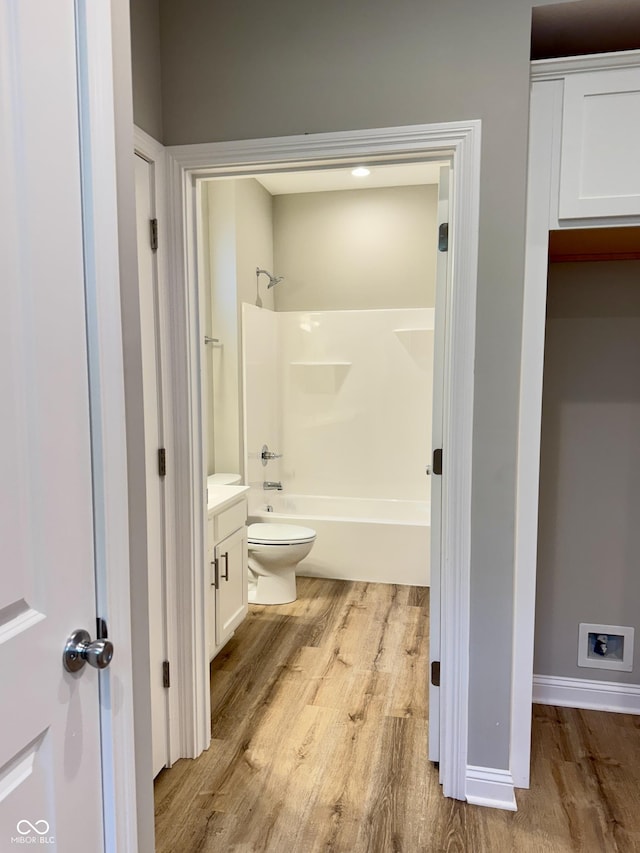 857 N Oakland Ave, Indianapolis, IN 46201 - bathroom featuring wood finished floors, vanity, toilet, shower / tub combination, and baseboards