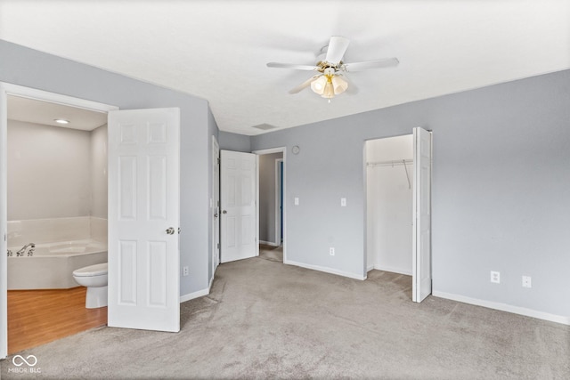 unfurnished bedroom featuring carpet, a closet, visible vents, a ceiling fan, and baseboards