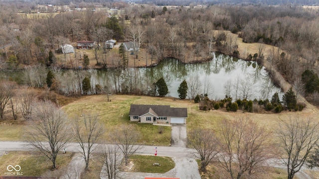 aerial view featuring a water view and a wooded view