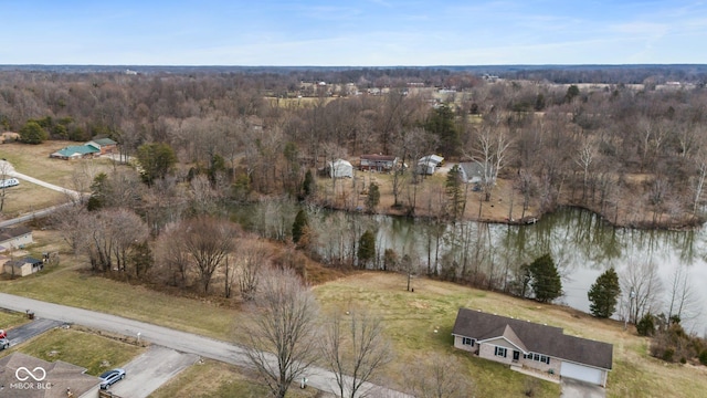 aerial view featuring a forest view and a water view