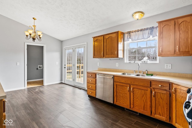 kitchen with a sink, dark wood-style floors, brown cabinets, and stainless steel dishwasher