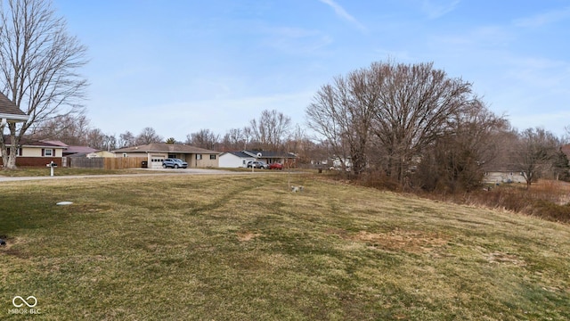 view of yard featuring a carport and fence