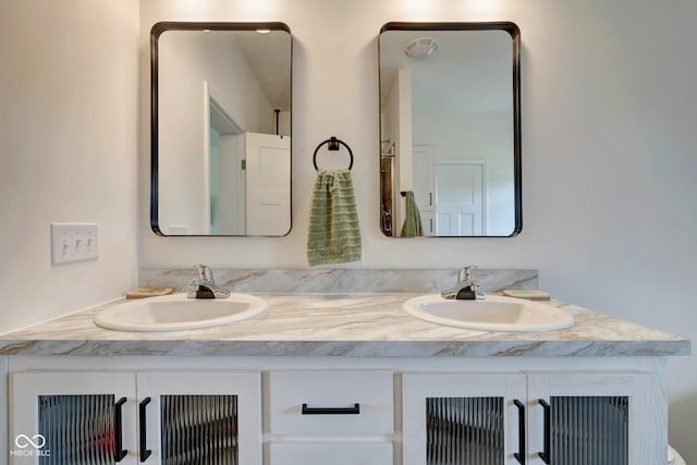 bathroom with double vanity and a sink