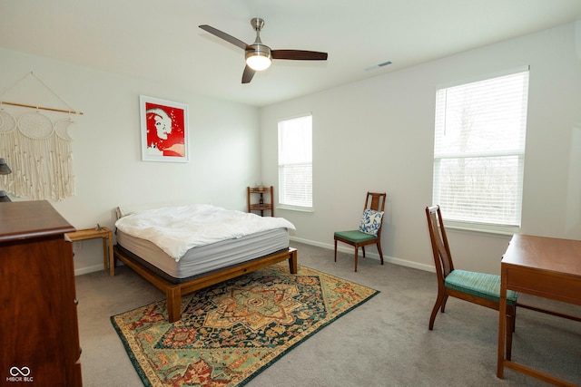 carpeted bedroom with ceiling fan, visible vents, and baseboards