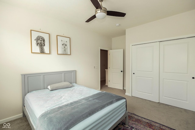 carpeted bedroom with a closet, ceiling fan, and baseboards