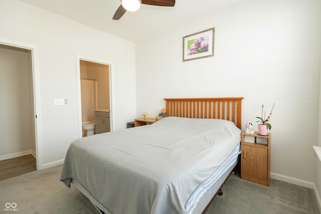 carpeted bedroom featuring ceiling fan, connected bathroom, and baseboards