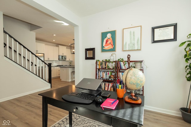 office area featuring light wood-style floors, recessed lighting, and baseboards