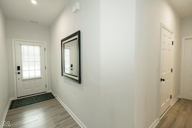 entryway with recessed lighting, baseboards, visible vents, and light wood finished floors