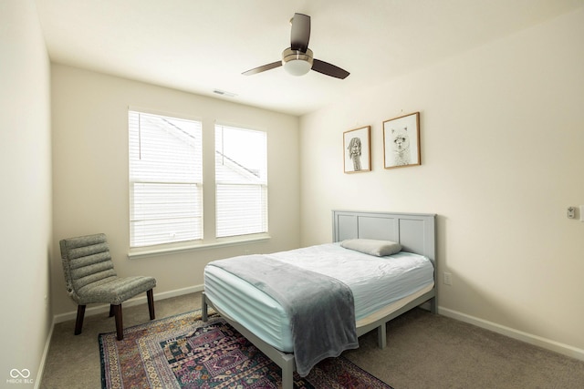 bedroom with a ceiling fan, carpet flooring, visible vents, and baseboards