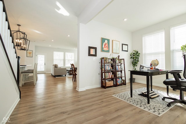 office space with light wood-style floors, recessed lighting, a chandelier, and baseboards