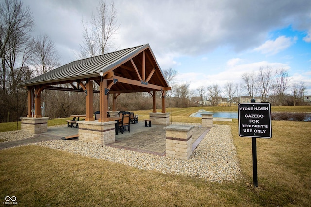 view of property's community with a patio, a lawn, and a gazebo