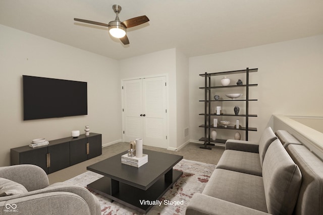 carpeted living room with ceiling fan, visible vents, and baseboards