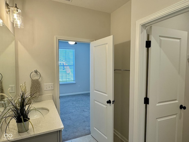bathroom featuring vanity and baseboards