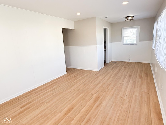 spare room with a wainscoted wall, light wood-type flooring, and recessed lighting