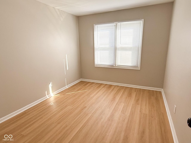 unfurnished room with light wood-style floors and baseboards