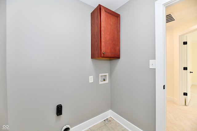 laundry room with visible vents, baseboards, washer hookup, light tile patterned floors, and cabinet space