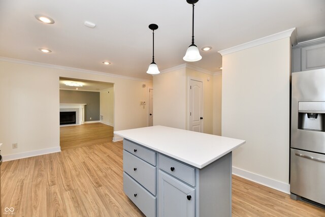 kitchen featuring light wood-style flooring, gray cabinetry, pendant lighting, and stainless steel fridge with ice dispenser