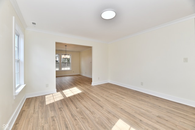 unfurnished room featuring visible vents, baseboards, a chandelier, ornamental molding, and light wood-style floors