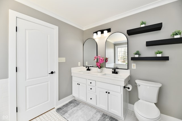 full bathroom featuring a sink, toilet, ornamental molding, and double vanity