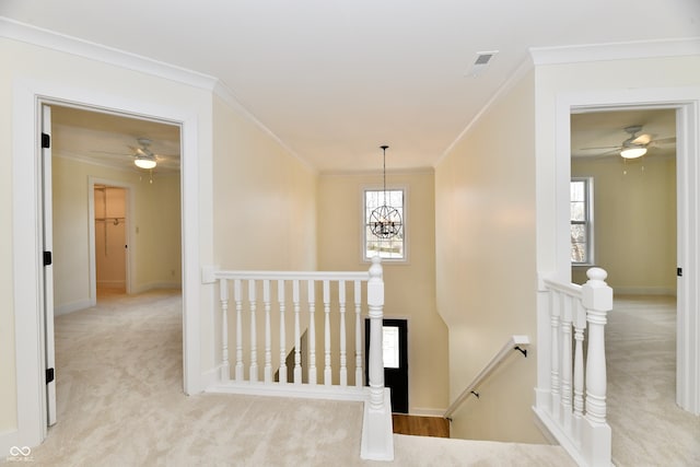 corridor featuring crown molding, carpet flooring, an upstairs landing, and baseboards