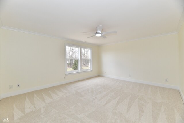 spare room with baseboards, light carpet, and crown molding