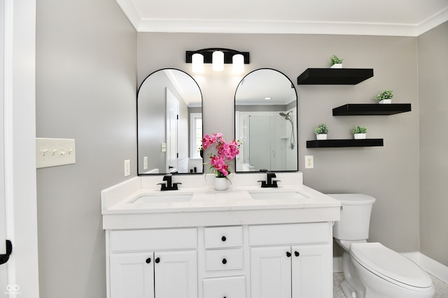 bathroom featuring crown molding, toilet, a stall shower, and a sink