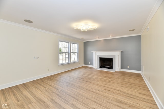 unfurnished living room featuring baseboards, ornamental molding, a fireplace, and light wood finished floors