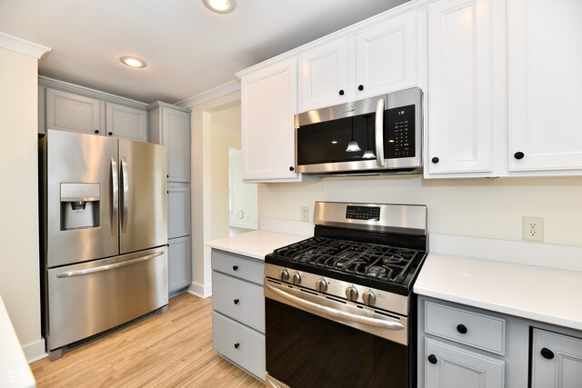 kitchen with light wood-style flooring, gray cabinets, recessed lighting, appliances with stainless steel finishes, and light countertops