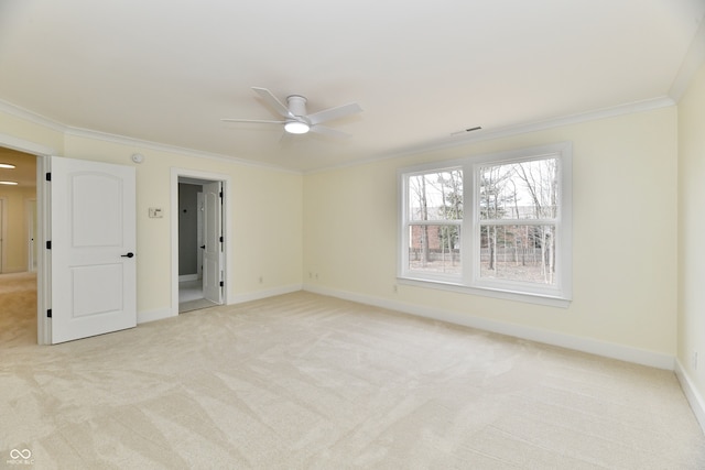 interior space featuring visible vents, light carpet, ornamental molding, a ceiling fan, and baseboards