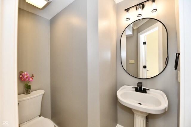 bathroom with toilet and a sink