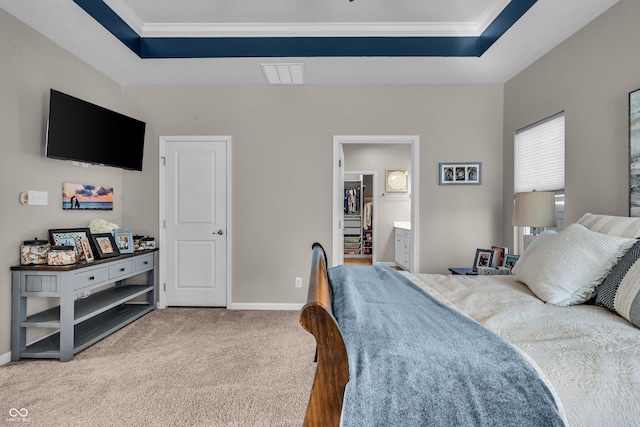 carpeted bedroom featuring ornamental molding, a tray ceiling, visible vents, and baseboards