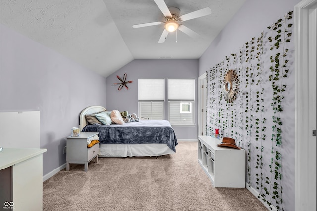 carpeted bedroom with a ceiling fan, lofted ceiling, a textured ceiling, and baseboards