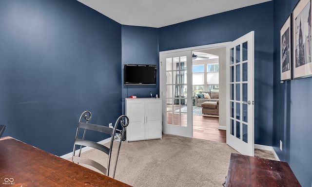 carpeted office with ceiling fan, baseboards, and french doors