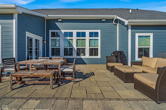 view of patio featuring outdoor dining area, french doors, and an outdoor living space