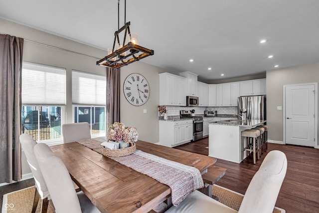 dining room featuring dark wood-style flooring, a toaster, recessed lighting, a chandelier, and baseboards