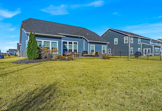 rear view of house featuring a yard, a patio area, and fence