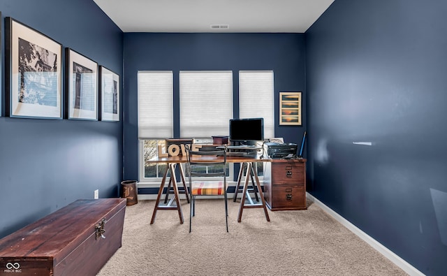 carpeted office featuring baseboards and visible vents