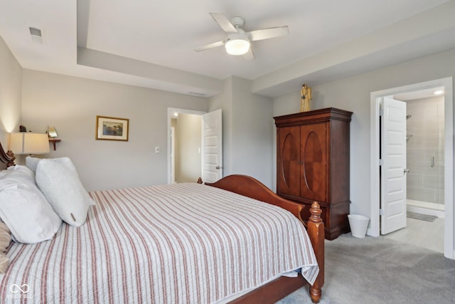 bedroom featuring light carpet, visible vents, ensuite bathroom, and ceiling fan