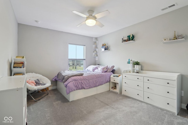 bedroom featuring visible vents, light colored carpet, and ceiling fan