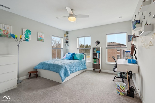 carpeted bedroom featuring visible vents, baseboards, and a ceiling fan